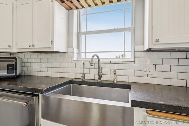 31102 S 4190th Rd, Inola, OK 74036 - kitchen featuring white cabinetry, decorative backsplash, and stainless steel dishwasher