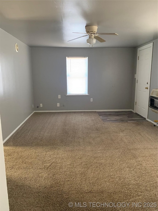 921 E 2nd St, Cushing, OK 74023 - carpeted empty room featuring heating unit, baseboards, and a ceiling fan