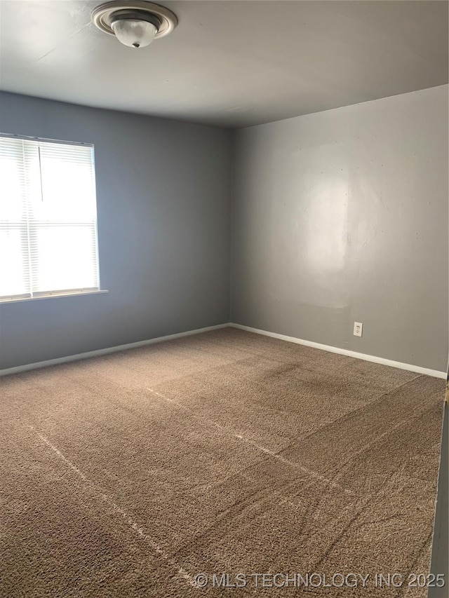 921 E 2nd St, Cushing, OK 74023 - carpeted spare room with baseboards