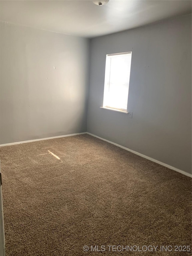 921 E 2nd St, Cushing, OK 74023 - spare room with carpet flooring and baseboards