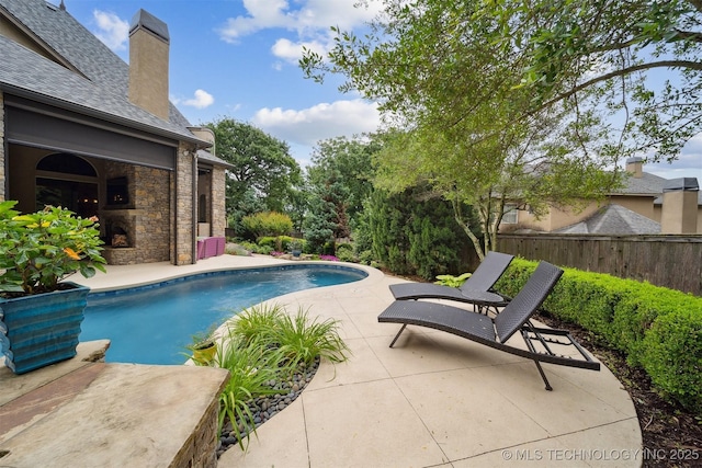 5912 E 119th St, Tulsa, OK 74137 - view of pool with a patio area and an outdoor fireplace