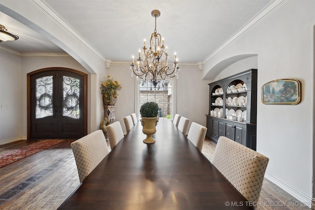 5912 E 119th St, Tulsa, OK 74137 - dining room with arched walkways, a chandelier, wood finished floors, french doors, and ornamental molding