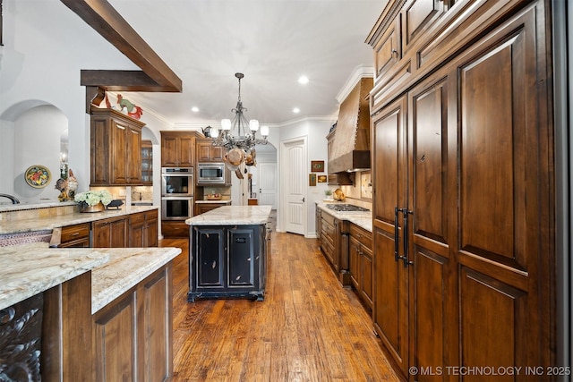 5912 E 119th St, Tulsa, OK 74137 - kitchen with a chandelier, appliances with stainless steel finishes, decorative backsplash, crown molding, and light stone countertops