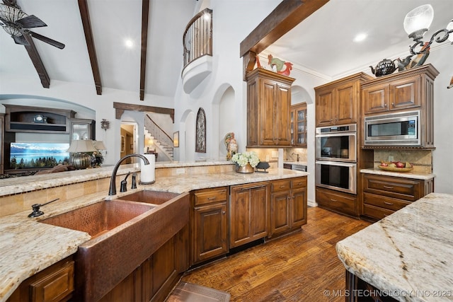 5912 E 119th St, Tulsa, OK 74137 - kitchen featuring appliances with stainless steel finishes, beamed ceiling, light stone countertops, decorative backsplash, and dark wood-style flooring