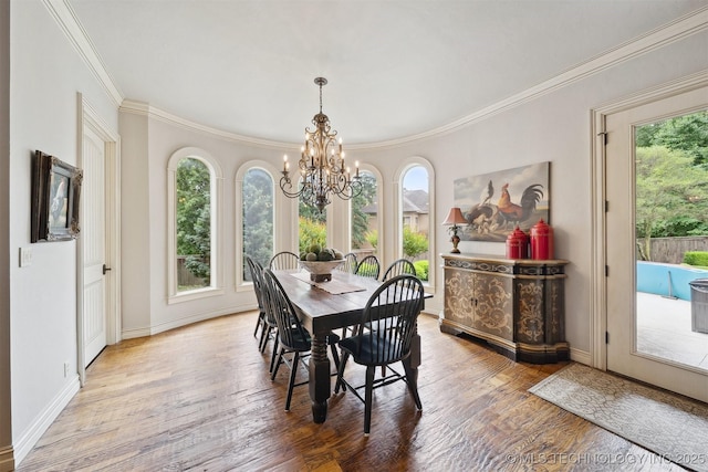 5912 E 119th St, Tulsa, OK 74137 - dining area with a chandelier, healthy amount of natural light, ornamental molding, and wood finished floors