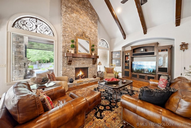 5912 E 119th St, Tulsa, OK 74137 - living area featuring high vaulted ceiling, beamed ceiling, a stone fireplace, and wood finished floors