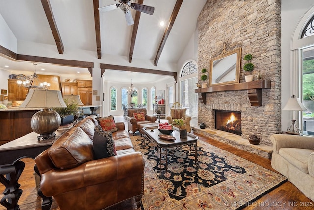 5912 E 119th St, Tulsa, OK 74137 - living area with a chandelier, wood finished floors, beam ceiling, ceiling fan, and a stone fireplace