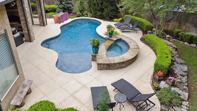 5912 E 119th St, Tulsa, OK 74137 - view of pool with a fireplace, a patio area, a fenced backyard, and a pool with connected hot tub