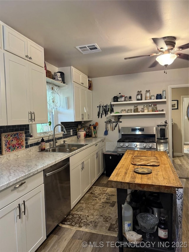 1436 E Broadway, Cushing, OK 74023 - kitchen with open shelves, stainless steel appliances, a sink, dark wood-style floors, and wood counters