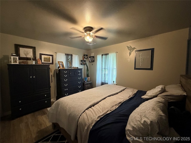 1436 E Broadway, Cushing, OK 74023 - bedroom with wood finished floors and a ceiling fan