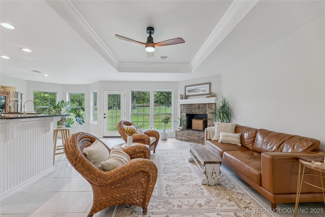 11587 W 86th St S, Sapulpa, OK 74066 - living room with healthy amount of natural light, a tray ceiling, ceiling fan, ornamental molding, and a fireplace