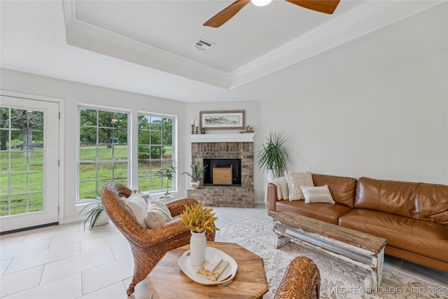 11587 W 86th St S, Sapulpa, OK 74066 - living area with light tile patterned floors, a tray ceiling, ceiling fan, a brick fireplace, and ornamental molding