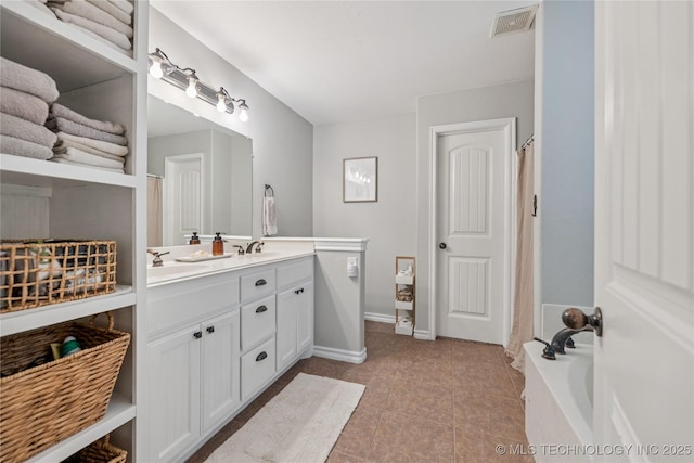 11587 W 86th St S, Sapulpa, OK 74066 - full bath with double vanity, a bathtub, tile patterned floors, and baseboards