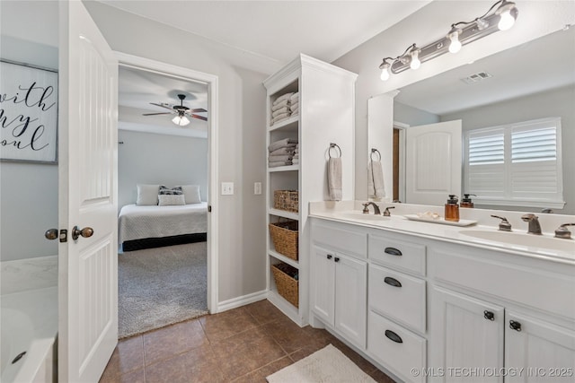 11587 W 86th St S, Sapulpa, OK 74066 - full bathroom featuring double vanity, ensuite bathroom, ceiling fan, tile patterned flooring, and baseboards