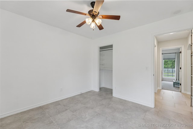 11587 W 86th St S, Sapulpa, OK 74066 - unfurnished bedroom with light tile patterned flooring, baseboards, a closet, and a ceiling fan