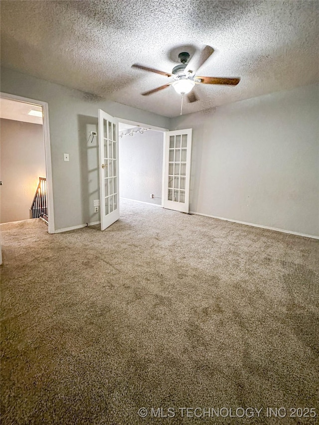 2213 E 67th St Unit 1405, Tulsa, OK 74136 - carpeted empty room with french doors, a ceiling fan, a textured ceiling, and baseboards