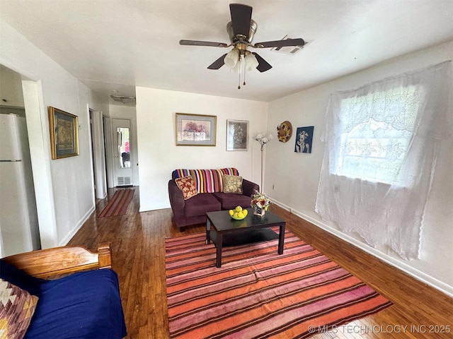 226 W Seneca St, Tahlequah, OK 74464 - living room with wood finished floors, ceiling fan, and baseboards
