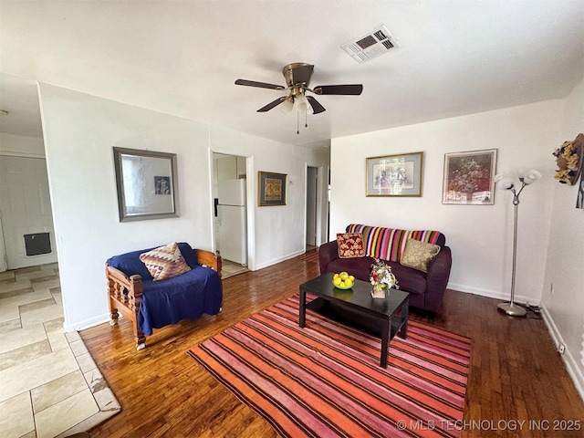 226 W Seneca St, Tahlequah, OK 74464 - living room with wood finished floors, a ceiling fan, and baseboards