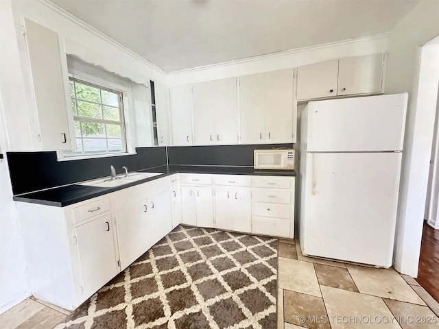 226 W Seneca St, Tahlequah, OK 74464 - kitchen with white appliances, dark countertops, a sink, and crown molding
