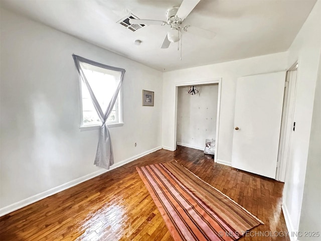 226 W Seneca St, Tahlequah, OK 74464 - unfurnished bedroom featuring hardwood / wood-style flooring, a closet, baseboards, and a ceiling fan