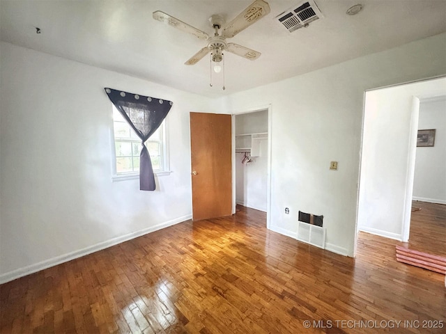 226 W Seneca St, Tahlequah, OK 74464 - unfurnished bedroom featuring hardwood / wood-style floors, a closet, baseboards, and a ceiling fan