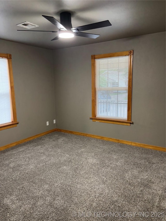910 E Maple St, Cushing, OK 74023 - carpeted spare room with baseboards and ceiling fan