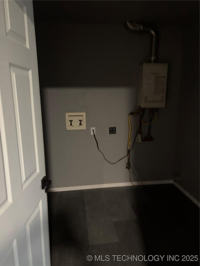 910 E Maple St, Cushing, OK 74023 - laundry room featuring water heater, washer hookup, and baseboards