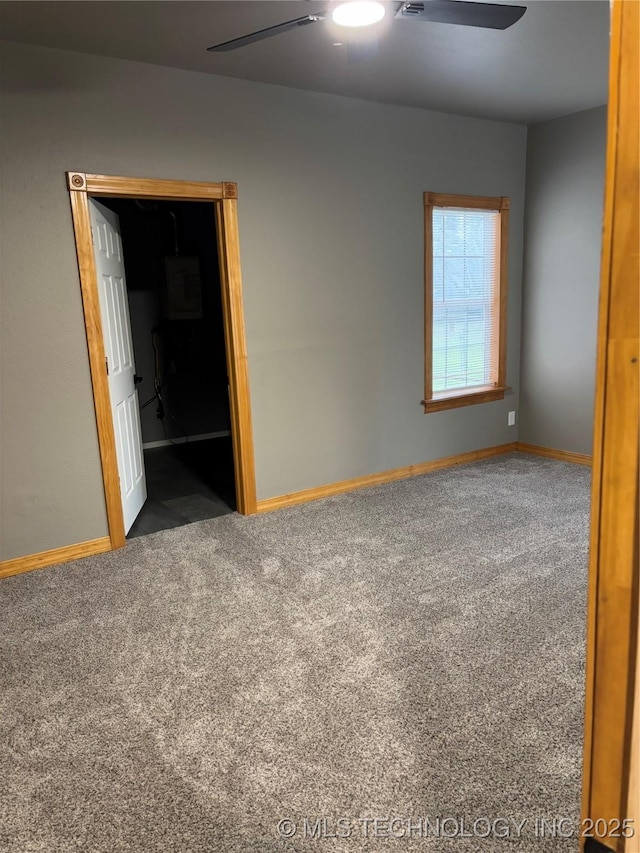 910 E Maple St, Cushing, OK 74023 - carpeted spare room with a ceiling fan and baseboards