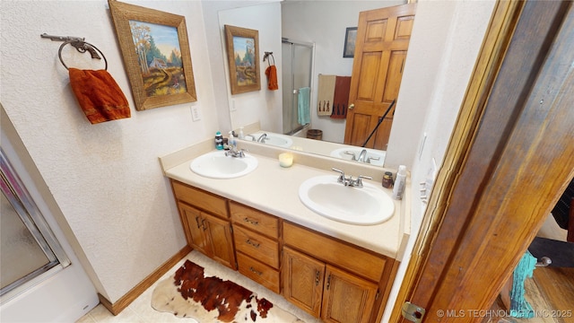 10815 State Highway 19, Ada, OK 74820 - bathroom with a shower with door, double vanity, a textured wall, and tile patterned flooring