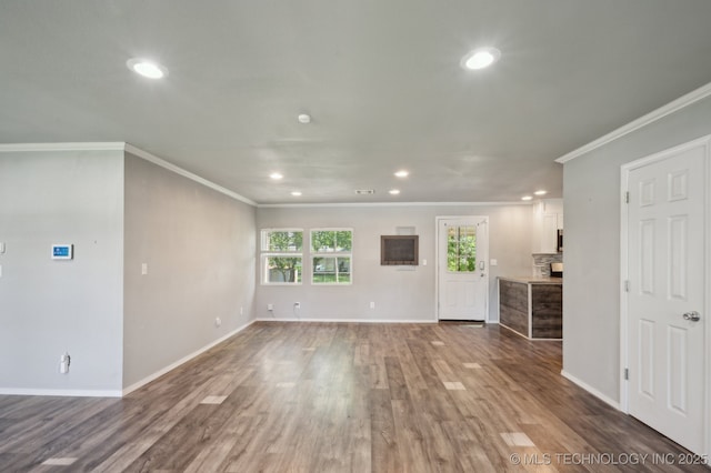 4126 E 36th Pl, Tulsa, OK 74135 - unfurnished living room featuring recessed lighting, ornamental molding, wood finished floors, and baseboards