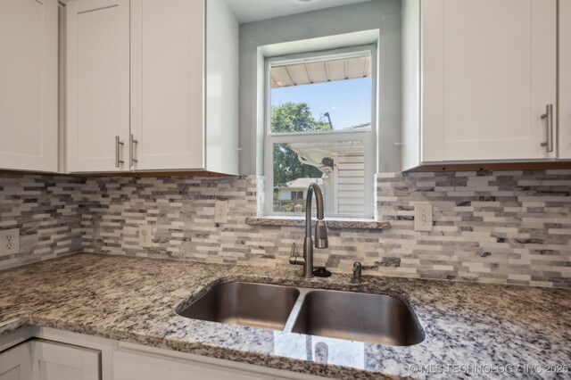 4126 E 36th Pl, Tulsa, OK 74135 - kitchen with a sink, white cabinets, and backsplash
