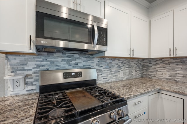 4126 E 36th Pl, Tulsa, OK 74135 - kitchen featuring stainless steel appliances, white cabinets, decorative backsplash, light stone countertops, and crown molding