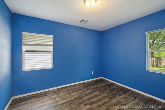 4126 E 36th Pl, Tulsa, OK 74135 - spare room featuring dark wood-style floors and baseboards