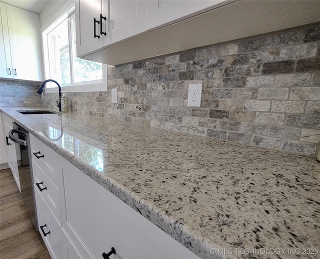 1400 NE 3rd St, Pryor, OK 74361 - kitchen with a sink, decorative backsplash, and white cabinetry