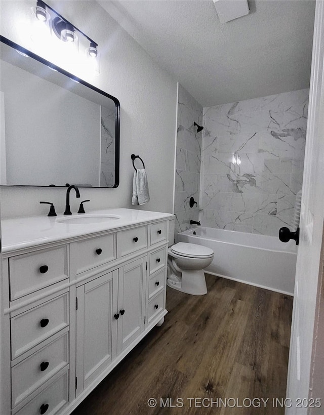 1400 NE 3rd St, Pryor, OK 74361 - bathroom featuring toilet, vanity, wood finished floors, shower / bath combination, and a textured ceiling