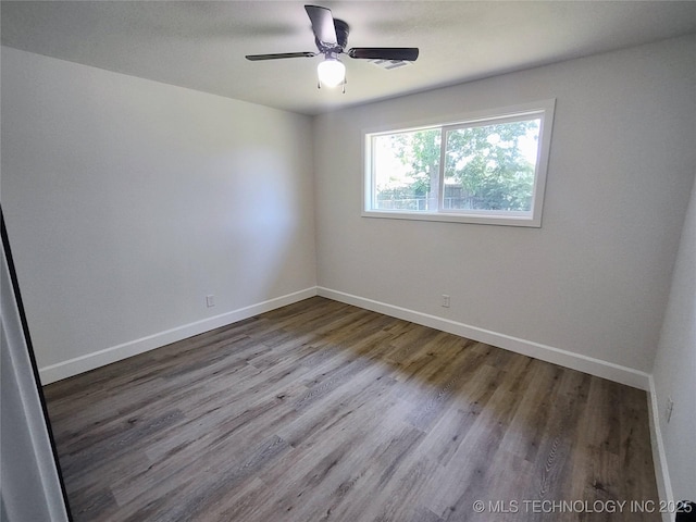 1400 NE 3rd St, Pryor, OK 74361 - spare room featuring wood finished floors, baseboards, and a ceiling fan
