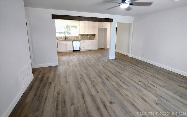 1400 NE 3rd St, Pryor, OK 74361 - unfurnished living room featuring a ceiling fan, light wood-style floors, a sink, and baseboards