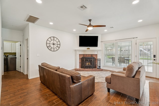 19804 E 45th St S, Broken Arrow, OK 74014 - living room with dark wood finished floors, washing machine and clothes dryer, a ceiling fan, a fireplace, and recessed lighting