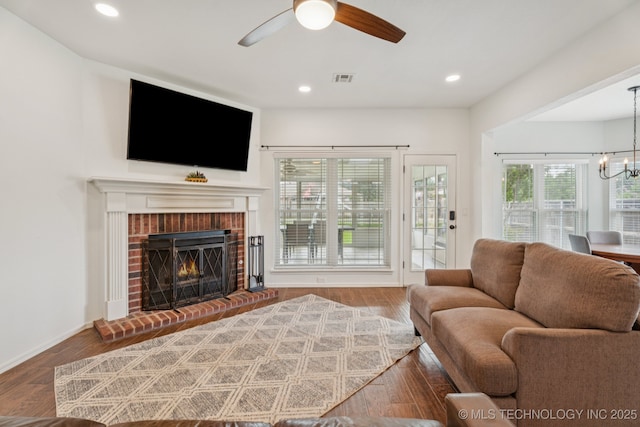 19804 E 45th St S, Broken Arrow, OK 74014 - living area with ceiling fan, wood finished floors, a fireplace, a chandelier, and recessed lighting