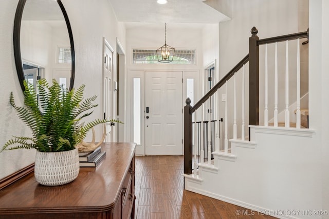 19804 E 45th St S, Broken Arrow, OK 74014 - foyer with stairs, a chandelier, baseboards, wood finished floors, and a towering ceiling