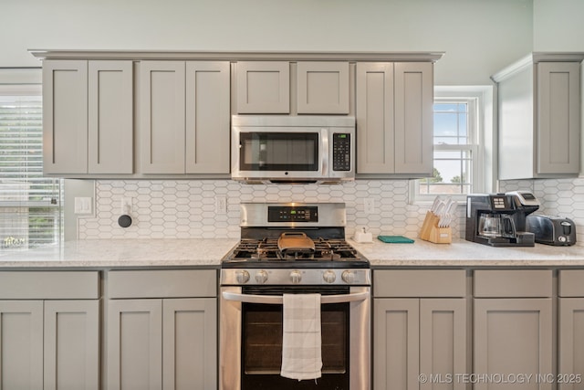 19804 E 45th St S, Broken Arrow, OK 74014 - kitchen featuring stainless steel appliances, gray cabinetry, and backsplash