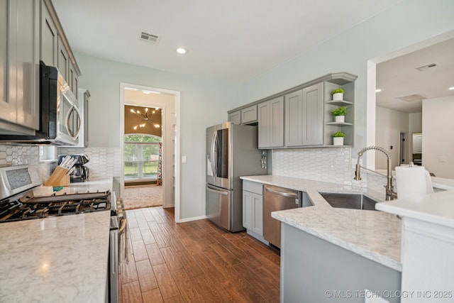 19804 E 45th St S, Broken Arrow, OK 74014 - kitchen featuring appliances with stainless steel finishes, a sink, open shelves, gray cabinetry, and dark wood finished floors