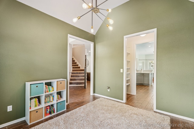 19804 E 45th St S, Broken Arrow, OK 74014 - playroom with a chandelier, wood finished floors, baseboards, and vaulted ceiling