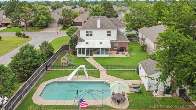 19804 E 45th St S, Broken Arrow, OK 74014 - rear view of house with a sunroom, brick siding, a playground, and a residential view