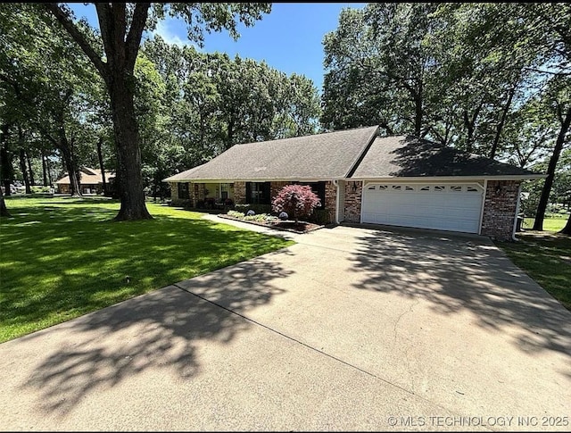 3109 Buffalo Ln, Grove, OK 74344 - ranch-style house with concrete driveway, a front lawn, an attached garage, and brick siding