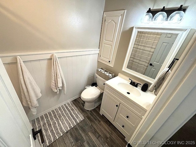 3109 Buffalo Ln, Grove, OK 74344 - bathroom with toilet, wood finished floors, vanity, and wainscoting