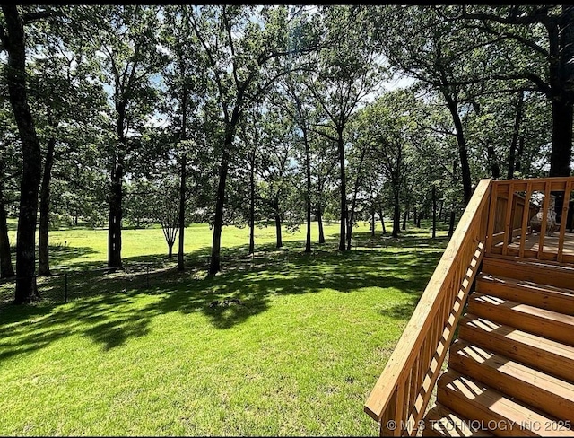 3109 Buffalo Ln, Grove, OK 74344 - view of grassy yard featuring a deck and view of scattered trees