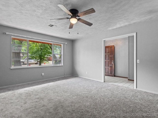 1921 S Santa Fe Pl, Bartlesville, OK 74003 - carpeted spare room featuring a textured ceiling and ceiling fan