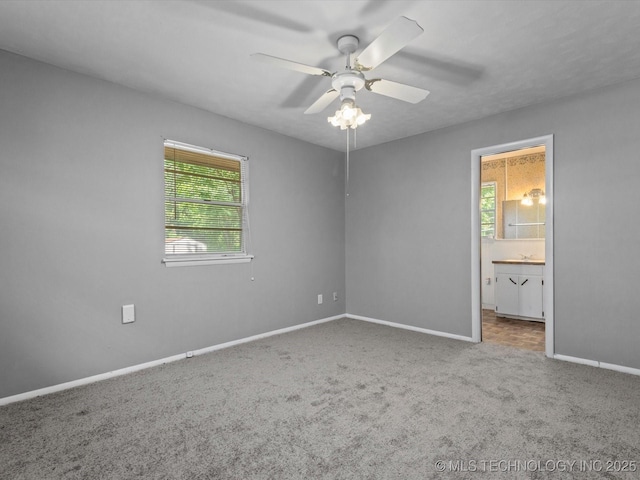 1921 S Santa Fe Pl, Bartlesville, OK 74003 - unfurnished bedroom featuring carpet, ensuite bathroom, and ceiling fan