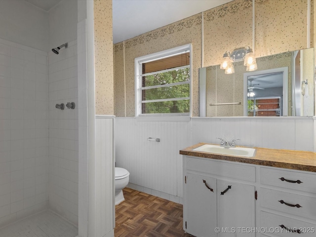 1921 S Santa Fe Pl, Bartlesville, OK 74003 - full bath with vanity, a tile shower, wainscoting, and ceiling fan